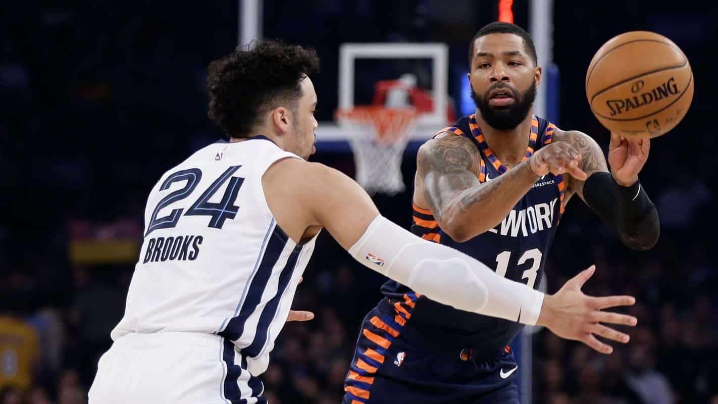 New York Knicks' Marcus Morris Sr. (13) passes the ball away from Memphis Grizzlies' Dillon Brooks (24) during the first half of an NBA basketball game Wednesday, Jan. 29, 2020, in New York.