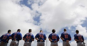 JUPITER, FLORIDA - FEBRUARY 22: The New York Mets observe the playing of the national anthem prior to a Grapefruit League spring training game against the St. Louis Cardinals at Roger Dean Stadium on February 22, 2020 in Jupiter, Florida.