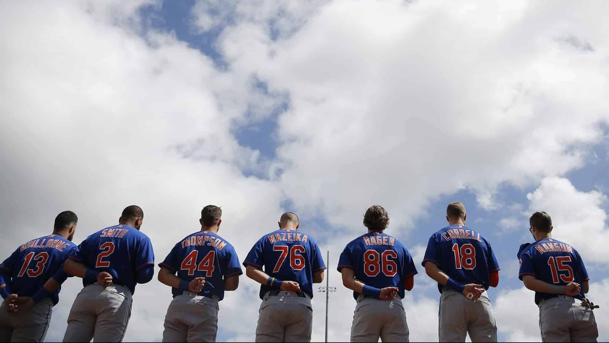 JUPITER, FLORIDA - FEBRUARY 22: The New York Mets observe the playing of the national anthem prior to a Grapefruit League spring training game against the St. Louis Cardinals at Roger Dean Stadium on February 22, 2020 in Jupiter, Florida.