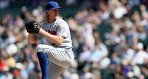 DENVER, COLORADO - SEPTEMBER 18: Starting pitcher Noah Syndergaard #34 of the New York Mets throws in the first inning against the Colorado Rockies at Coors Field on September 18, 2019 in Denver, Colorado.