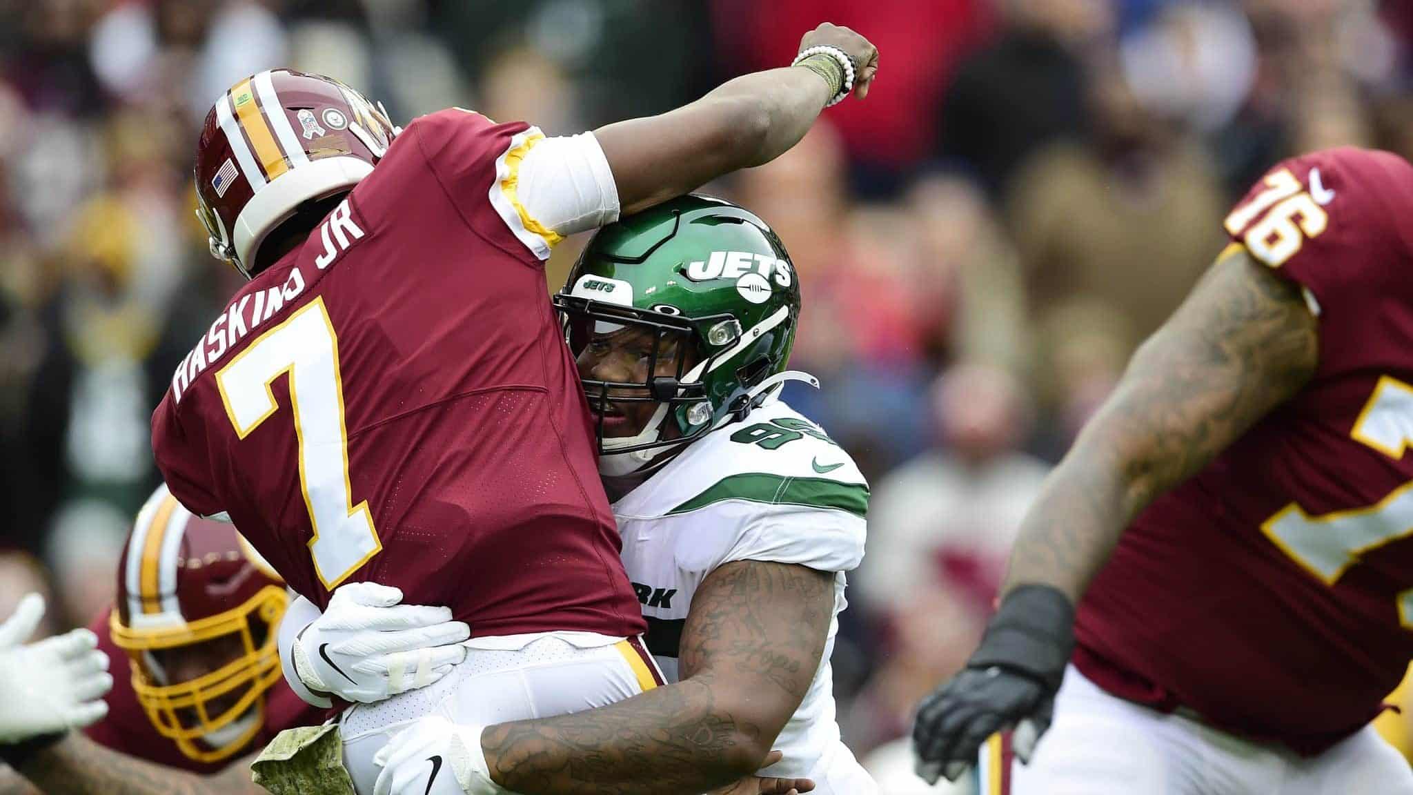 LANDOVER, MD - NOVEMBER 17: Dwayne Haskins #7 of the Washington Redskins is tackled by Quinnen Williams #95 of the New York Jets after throwing a pass in the first quarter at FedExField on November 17, 2019 in Landover, Maryland.