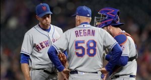 DENVER, COLORADO - SEPTEMBER 16: Starting pitcher Steven Matz #32 , pitching coach Phil Regan #58 and catcher Tomas Nido #3 of the New York Mets confer in the fourth inning against the Colorado Rockies at Coors Field on September 16, 2019 in Denver, Colorado.