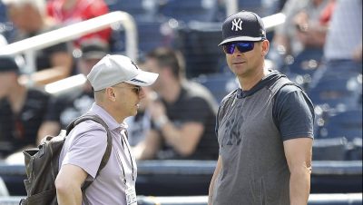 WEST PALM BEACH, FLORIDA - MARCH 12: New York Yankees general manager Brian Cashman talks with manager Aaron Boone prior to a Grapefruit League spring training game against the Washington Nationals at FITTEAM Ballpark of The Palm Beaches on March 12, 2020 in West Palm Beach, Florida. Many professional and college sports are canceling or postponing their games due to the ongoing threat of the Coronavirus (COVID-19) outbreak.