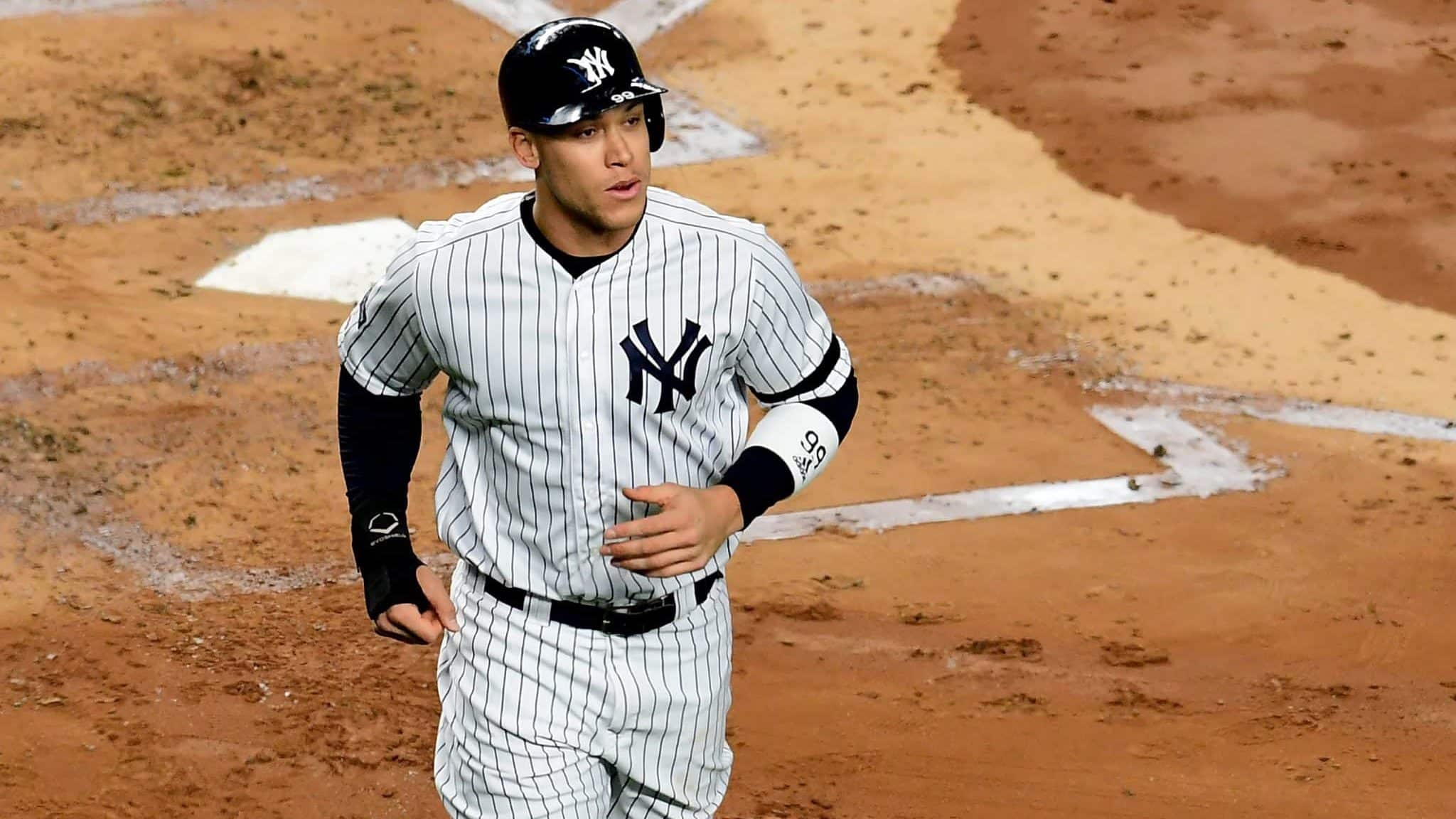 NEW YORK, NEW YORK - OCTOBER 17: Aaron Judge #99 of the New York Yankees looks on after scoring a run on a walk in the first inning against the Houston Astros during game three of the American League Championship Series at Yankee Stadium on October 17, 2019 in the Bronx borough of New York City.