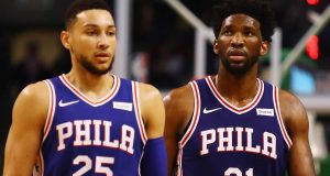 BOSTON, MA - JANUARY 18: Ben Simmons #25 and Joel Embiid #21 of the Philadelphia 76ers walk off the court during a time out in the second half against the Boston Celtics at TD Garden on January 18, 2018 in Boston, Massachusetts.