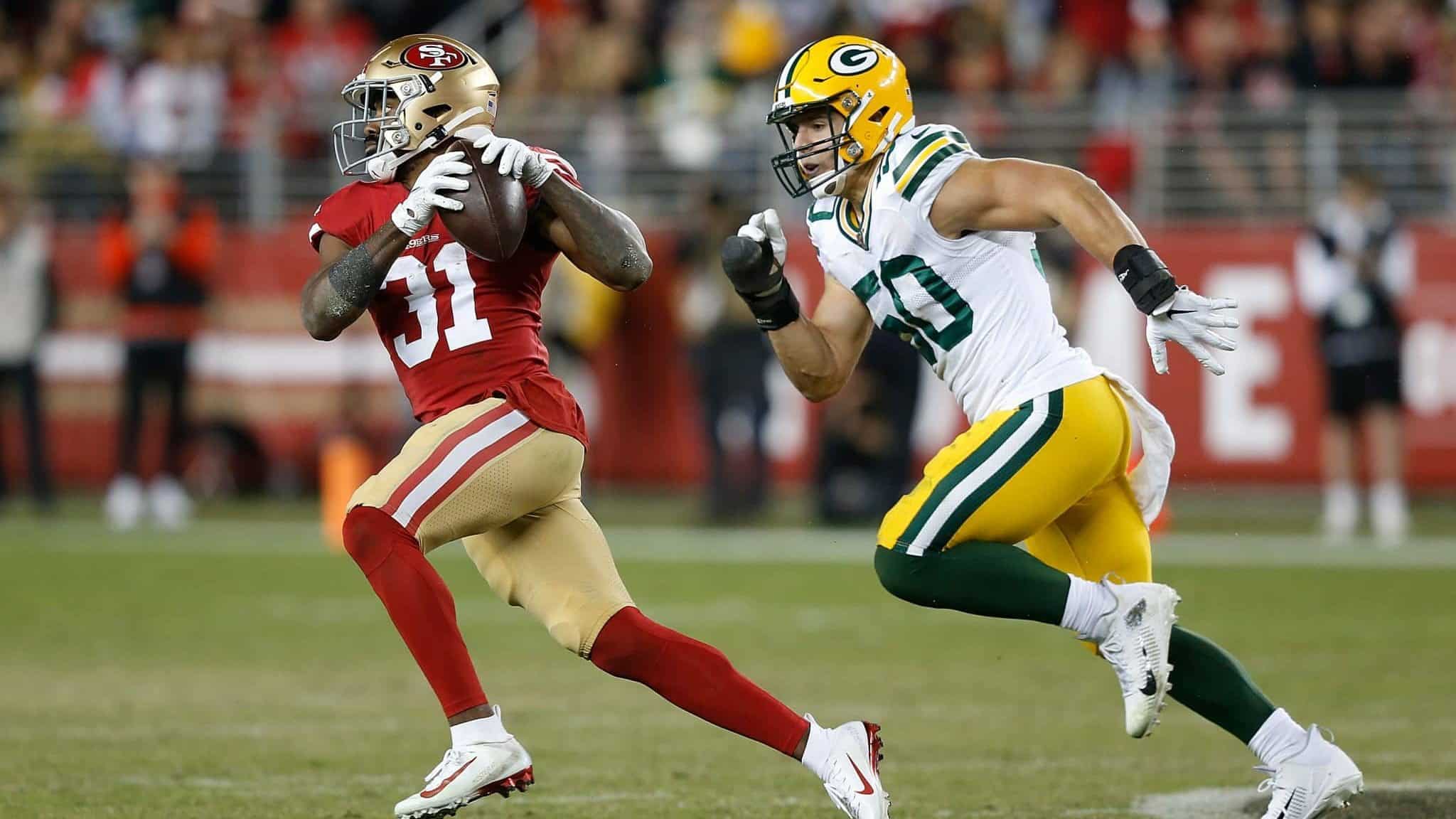 SANTA CLARA, CALIFORNIA - NOVEMBER 24: Raheem Mostert #31 of the San Francisco 49ers runs with the ball after making a catch in the fourth quarter against the Green Bay Packers at Levi's Stadium on November 24, 2019 in Santa Clara, California.