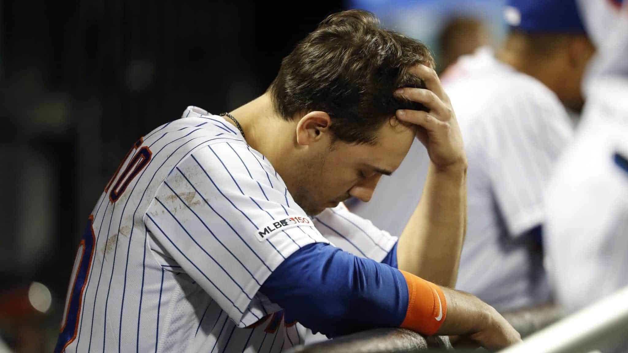 NEW YORK, NEW YORK - JUNE 04: Michael Conforto #30 of the New York Mets reacts in the dugout after striking out against the San Francisco Giants during the eighth inning at Citi Field on June 04, 2019 in New York City.