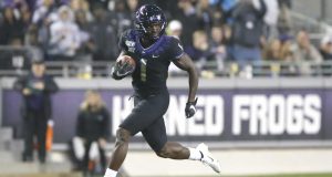 FORT WORTH, TX - NOVEMBER 29: Jalen Reagor #1 of the TCU Horned Frogs returns a punt for a touchdown against the West Virginia Mountaineers in the second half at Amon G. Carter Stadium on November 29, 2019 in Fort Worth, Texas. West Virginia won 20-17.