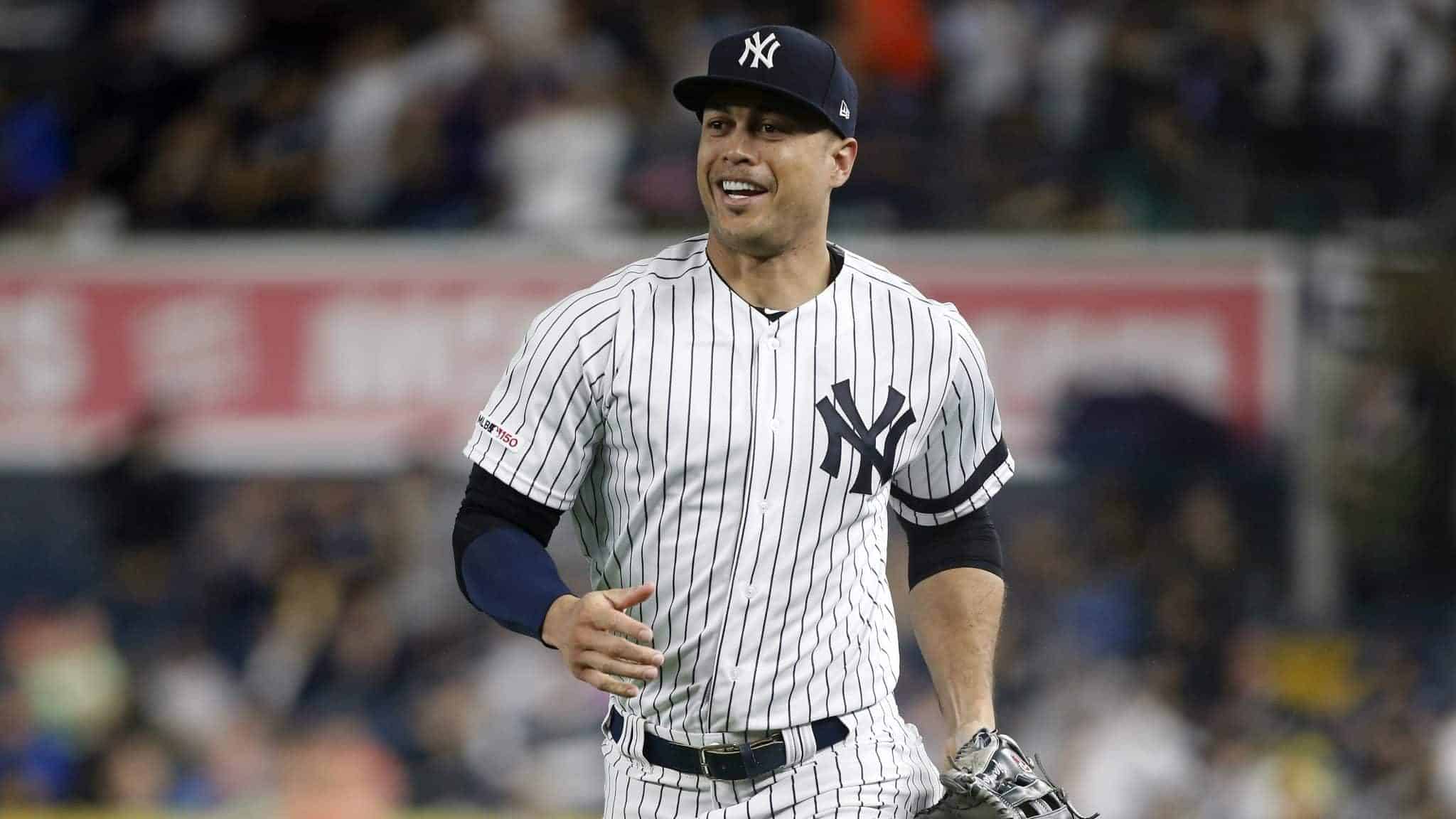 NEW YORK, NEW YORK - JUNE 18: Giancarlo Stanton #27 of the New York Yankees as he runs to the dugout after the first inning against the Tampa Bay Rays at Yankee Stadium on June 18, 2019 in New York City.