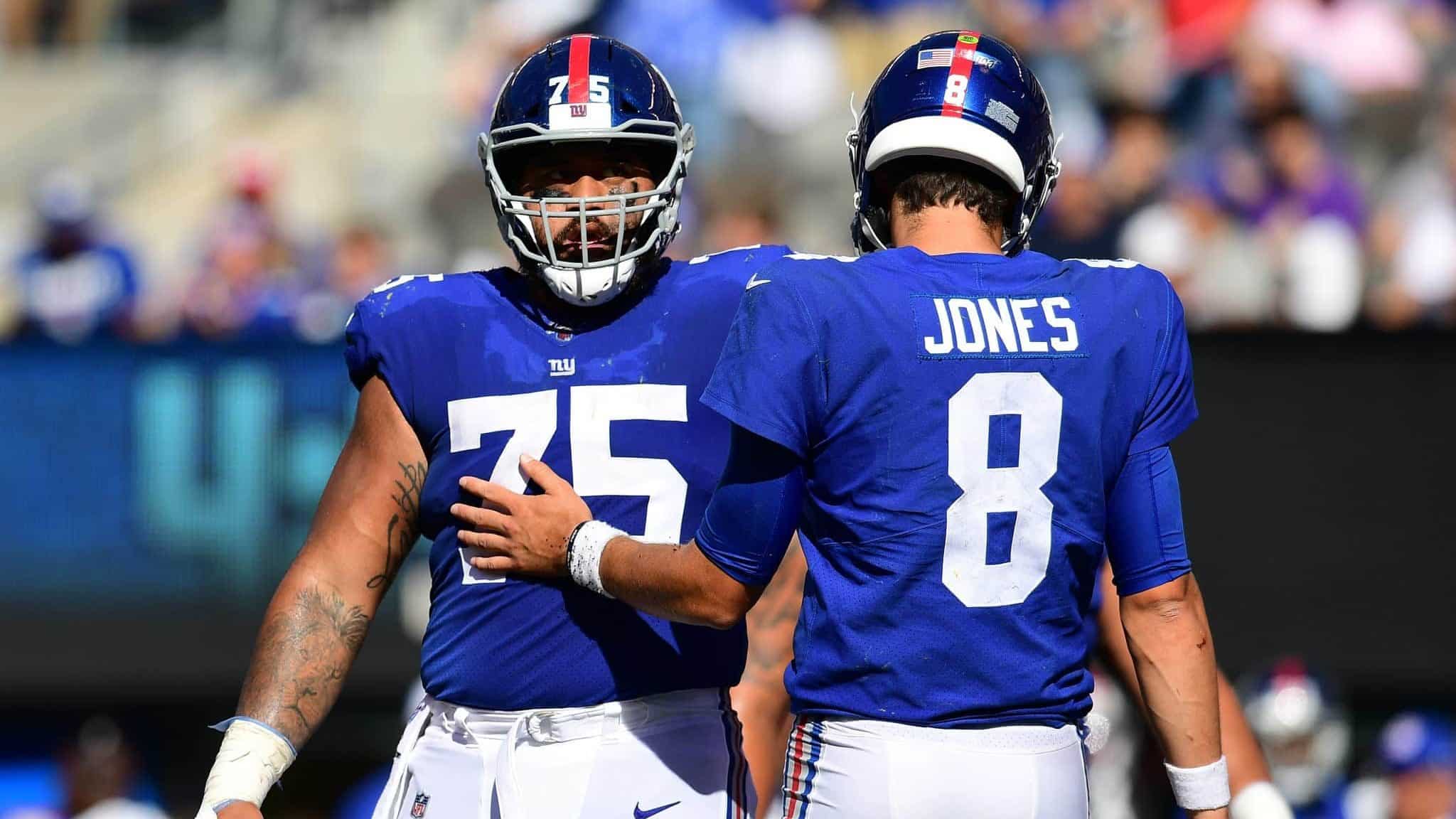 EAST RUTHERFORD, NEW JERSEY - SEPTEMBER 29: Daniel Jones #8 and Jon Halapio #75 of the New York Giants communicate during their game against the Washington Redskins at MetLife Stadium on September 29, 2019 in East Rutherford, New Jersey.