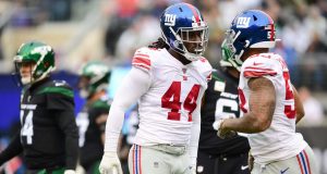 EAST RUTHERFORD, NEW JERSEY - NOVEMBER 10: Markus Golden #44 and Oshane Ximines #53 of the New York Giants react during the first half of their game against the New York Jets at MetLife Stadium on November 10, 2019 in East Rutherford, New Jersey.