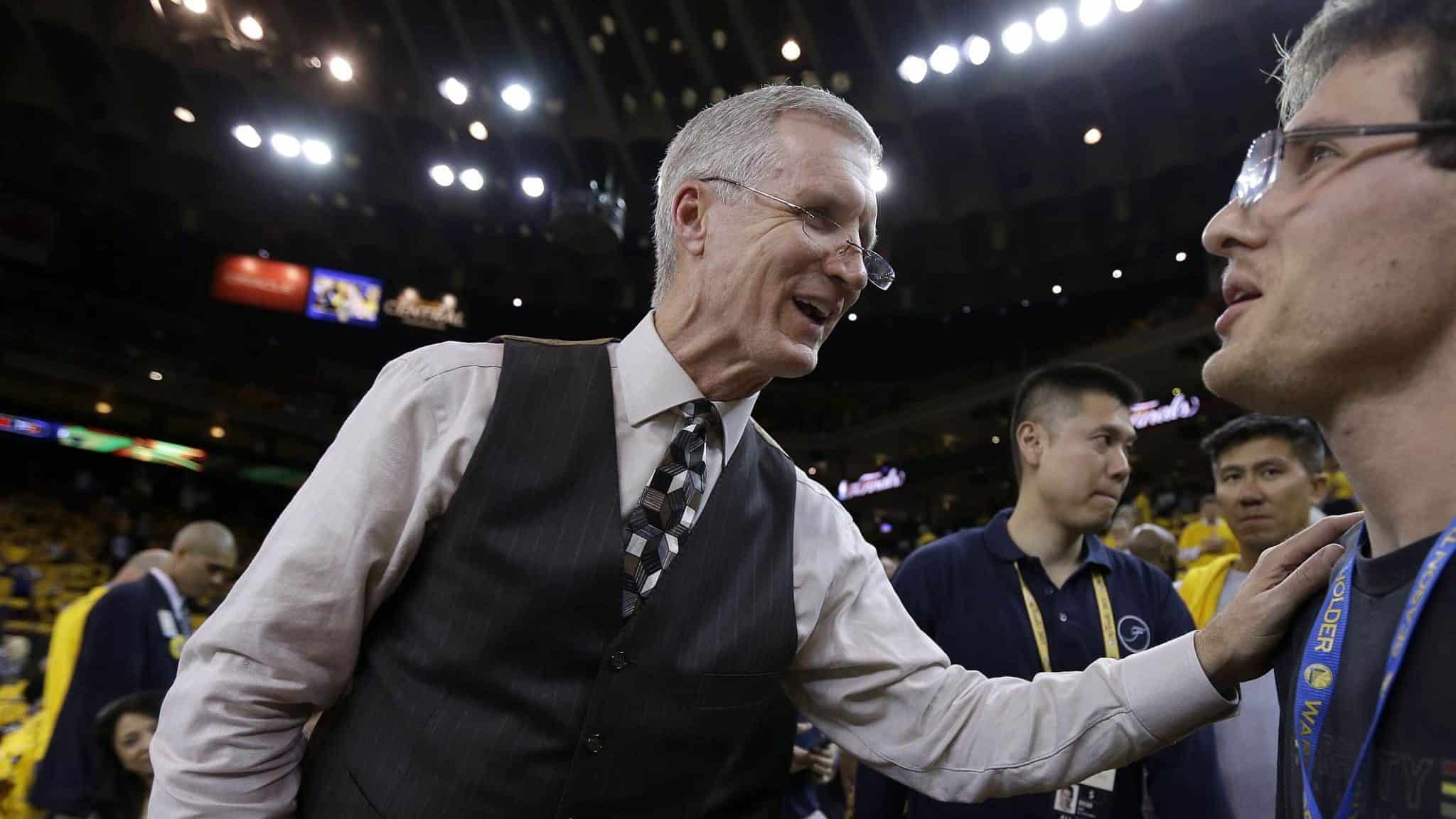In this June 4, 2015, photo, Mike Breen, NBA play-by-play sports commentator for ABC, greets fans before Game 1 of basketball's NBA Finals between the Golden State Warriors and Cleveland Cavaliers in Oakland, Calif. Breen is calling his 10th NBA Finals, a record for a TV play-by-play announcer.