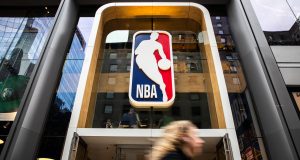 NEW YORK, NY - MARCH 12: A pedestrian walks past the NBA store on 5th Avenue on March 12, 2020 in New York City. The National Basketball Association said they would suspend all games after player Rudy Gobert of the Utah Jazz reportedly tested positive for the Coronavirus (COVID-19).