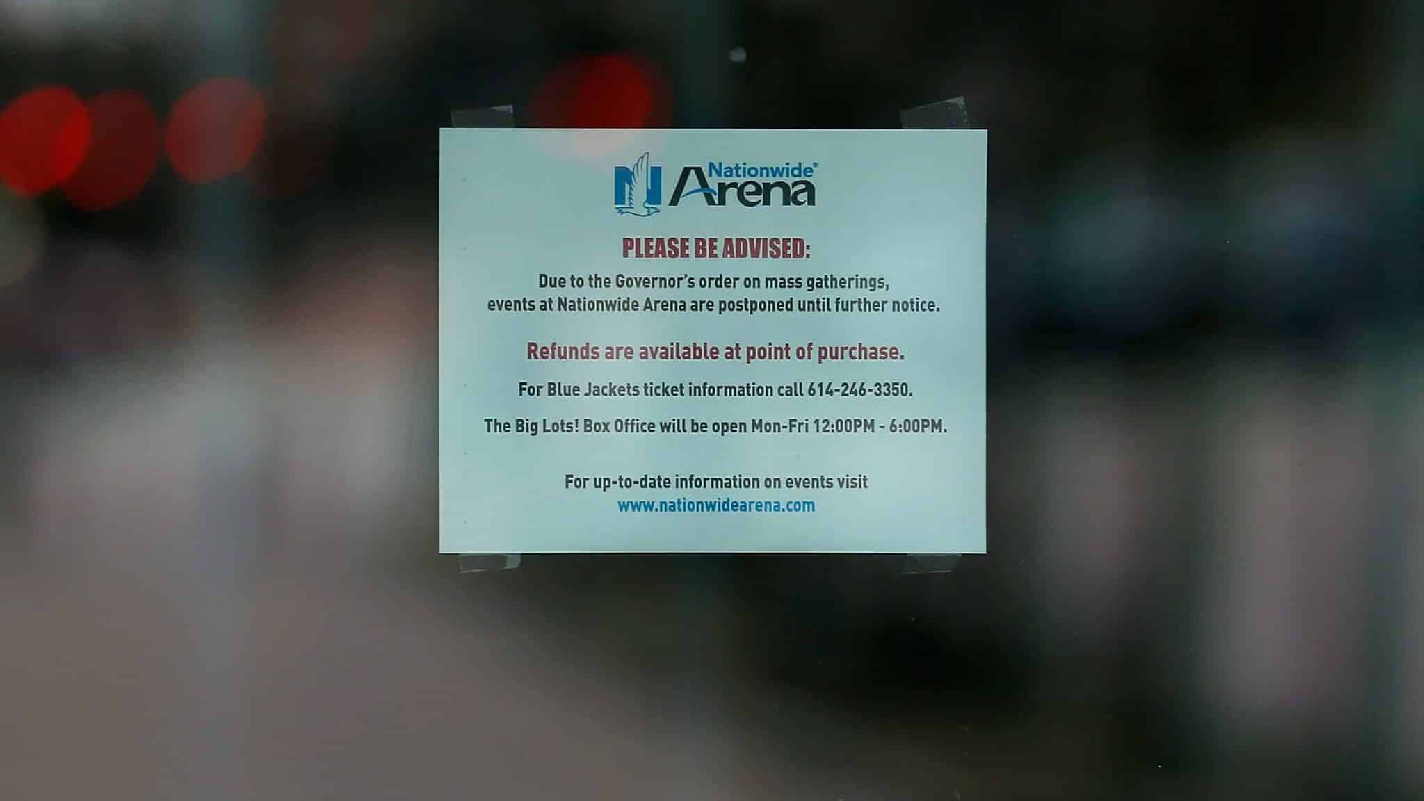 COLUMBUS, OH - MARCH 12: A sign posted on an entrance door to Nationwide Arena alerts fans that all events at the arena have been postponed on March 12, 2020 in Columbus, Ohio. The game between the Columbus Blue Jackets and the Pittsburgh Penguins was canceled after the NHL's decision to suspend the remaining games in the season due to the continuing outbreak of the coronavirus (COVID-19).