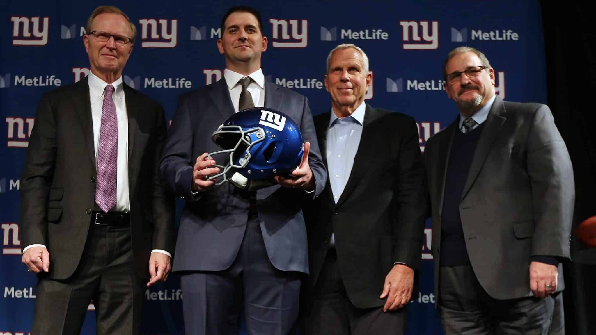 EAST RUTHERFORD, NJ - JANUARY 09: New York Giants new head coach Joe Judge, center, poses for photographs with team CEO John Mara, left, chairman and executive vice president Steve Tisch, and general manager Dave Gettleman, right, after a news conference at MetLife Stadium on January 9, 2020 in East Rutherford, New Jersey.