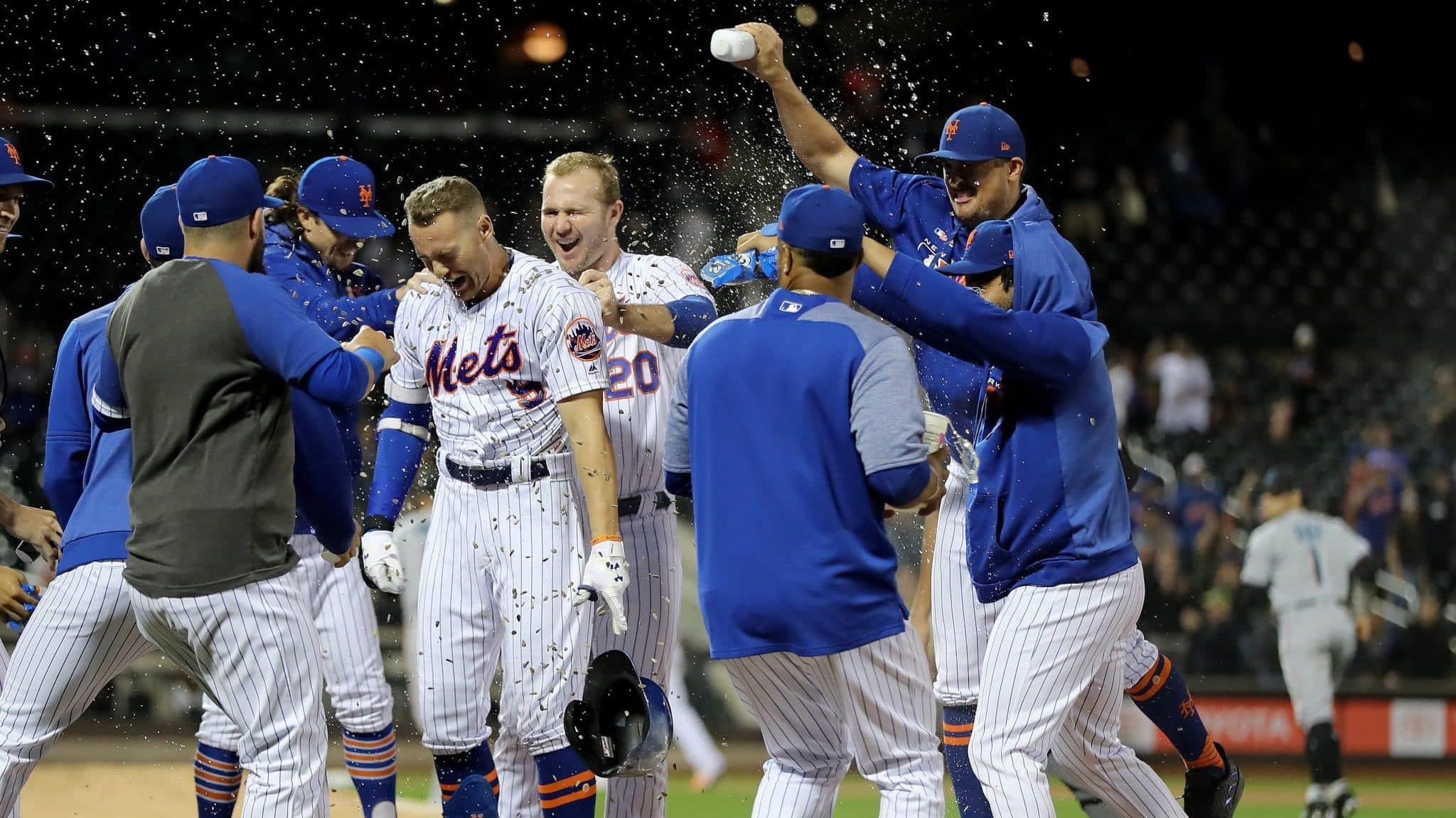 NEW YORK, NEW YORK - SEPTEMBER 24: Brandon Nimmo #9 of the New York Mets is congratulated by teammates as Pete Alonso #20 pulls at his jersey after Nimmo scored the game winning run with a bases loaded walk at Citi Field on September 24, 2019 in the Flushing neighborhood of the Queens borough of New York City.The New York Mets defeated the Miami Marlins 5-4 in 11 innings.