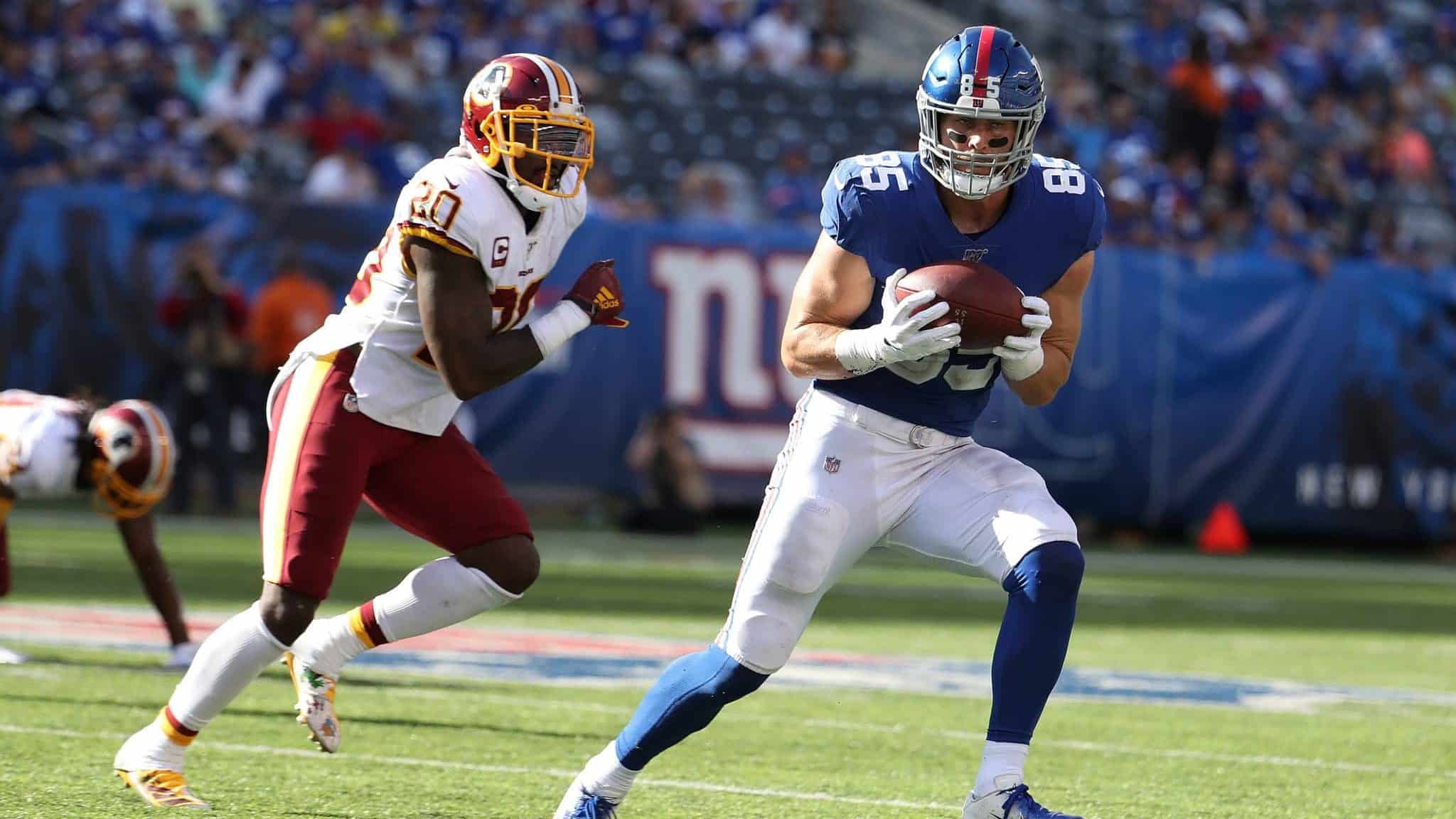 EAST RUTHERFORD, NEW JERSEY - SEPTEMBER 29: Rhett Ellison #85 of the New York Giants catches the ball against Landon Collins #20 of the Washington Redskins during their game at MetLife Stadium on September 29, 2019 in East Rutherford, New Jersey.
