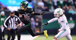 EAST RUTHERFORD, NEW JERSEY - DECEMBER 08: Robby Anderson #11 of the New York Jets is pushed out of bounds by Ryan Lewis #24 of the Miami Dolphins after completing a pass in the second half of their game at MetLife Stadium on December 08, 2019 in East Rutherford, New Jersey.