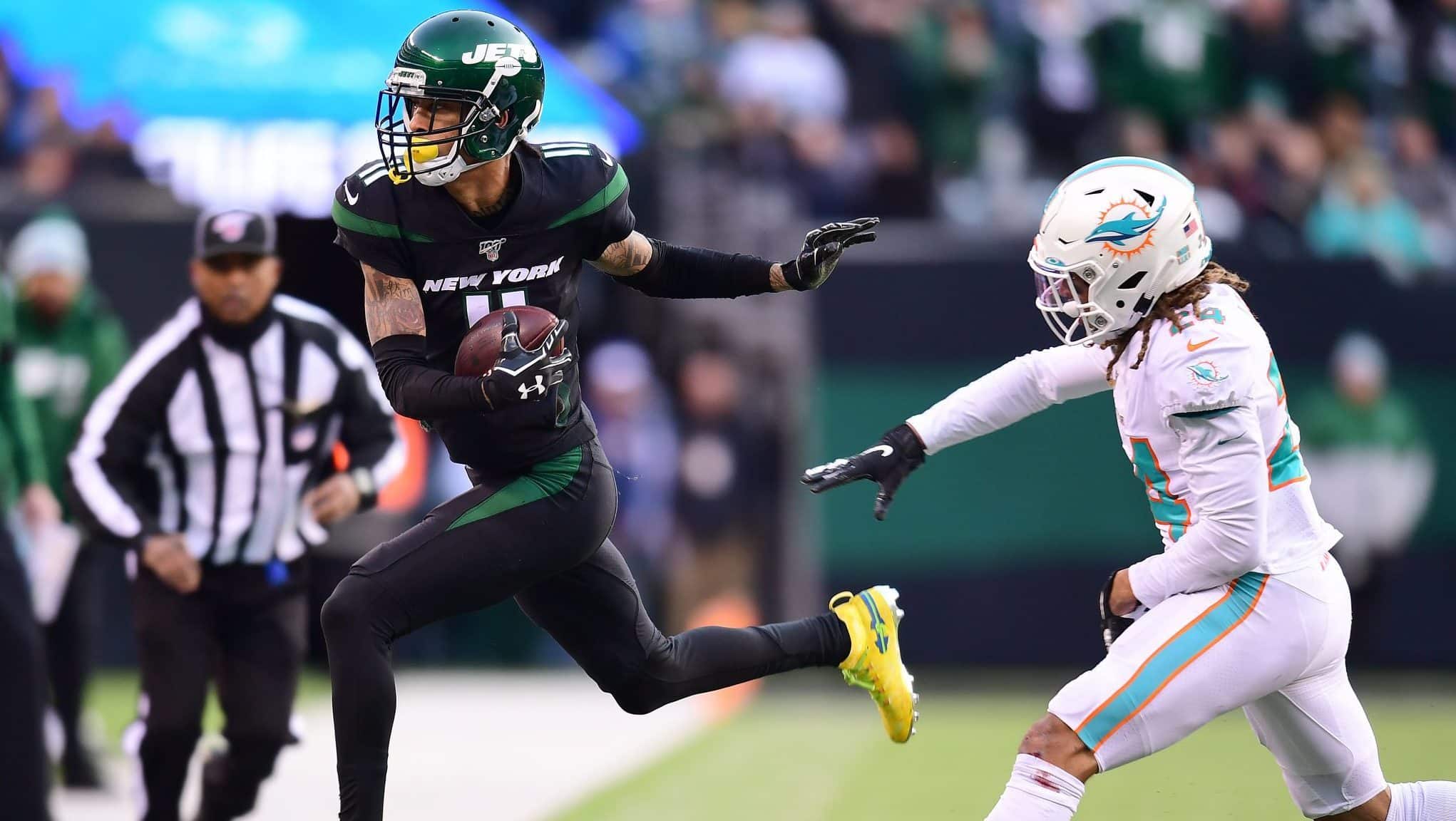EAST RUTHERFORD, NEW JERSEY - DECEMBER 08: Robby Anderson #11 of the New York Jets is pushed out of bounds by Ryan Lewis #24 of the Miami Dolphins after completing a pass in the second half of their game at MetLife Stadium on December 08, 2019 in East Rutherford, New Jersey.