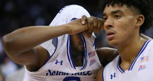 NEWARK, NJ - MARCH 04: Quincy McKnight #0 of the Seton Hall Pirates pulls his jersey over his head as he walks off the court with teammate Jared Rhoden #14 after losing to the Villanova Wildcats 79-77 in a college basketball game at Prudential Center on March 4, 2020 in Newark, New Jersey.