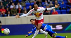HARRISON, NJ - MARCH 31: Thierry Henry #14 of the New York Red Bulls is challenged by Zarek Valentin #19 of the Montreal Impact at Red Bull Arena on March 31, 2012 in Harrison, New Jersey.