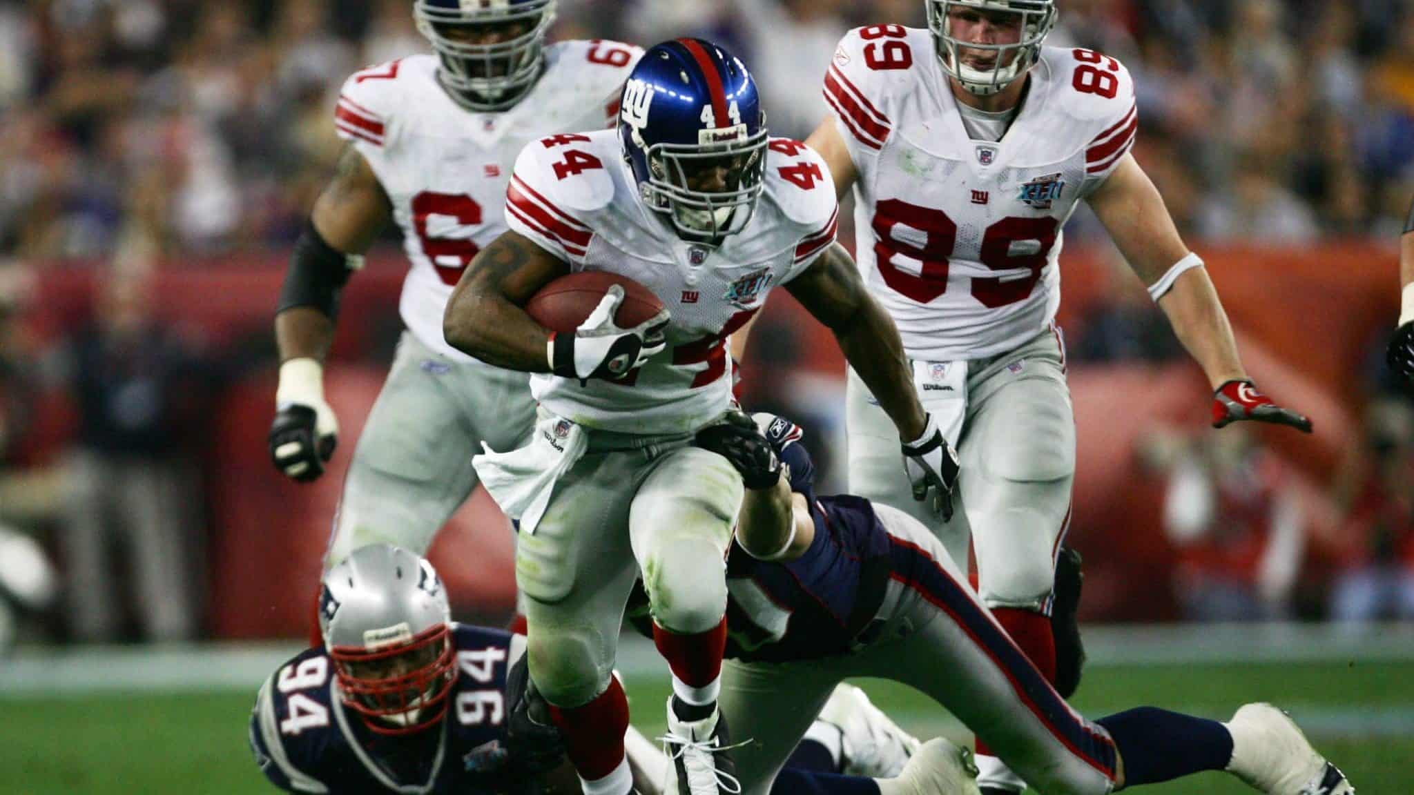 GLENDALE, AZ - FEBRUARY 03: Running back Ahmad Bradshaw #44 of the New York Giants carries the football through the New England Patriots defense in the second quarter during Super Bowl XLII on February 3, 2008 at the University of Phoenix Stadium in Glendale, Arizona.