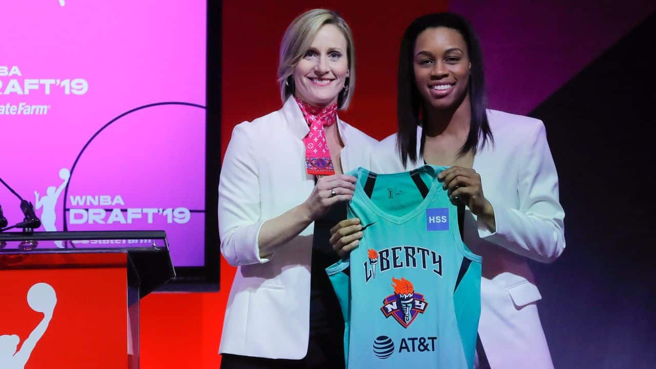 Louisville's Asia Durr, right, poses for photo with WNBA COO Christi Hedgpeth after being selected by the New York Liberty as the second overall pick in the WNBA basketball draft, Wednesday, April 10, 2019.