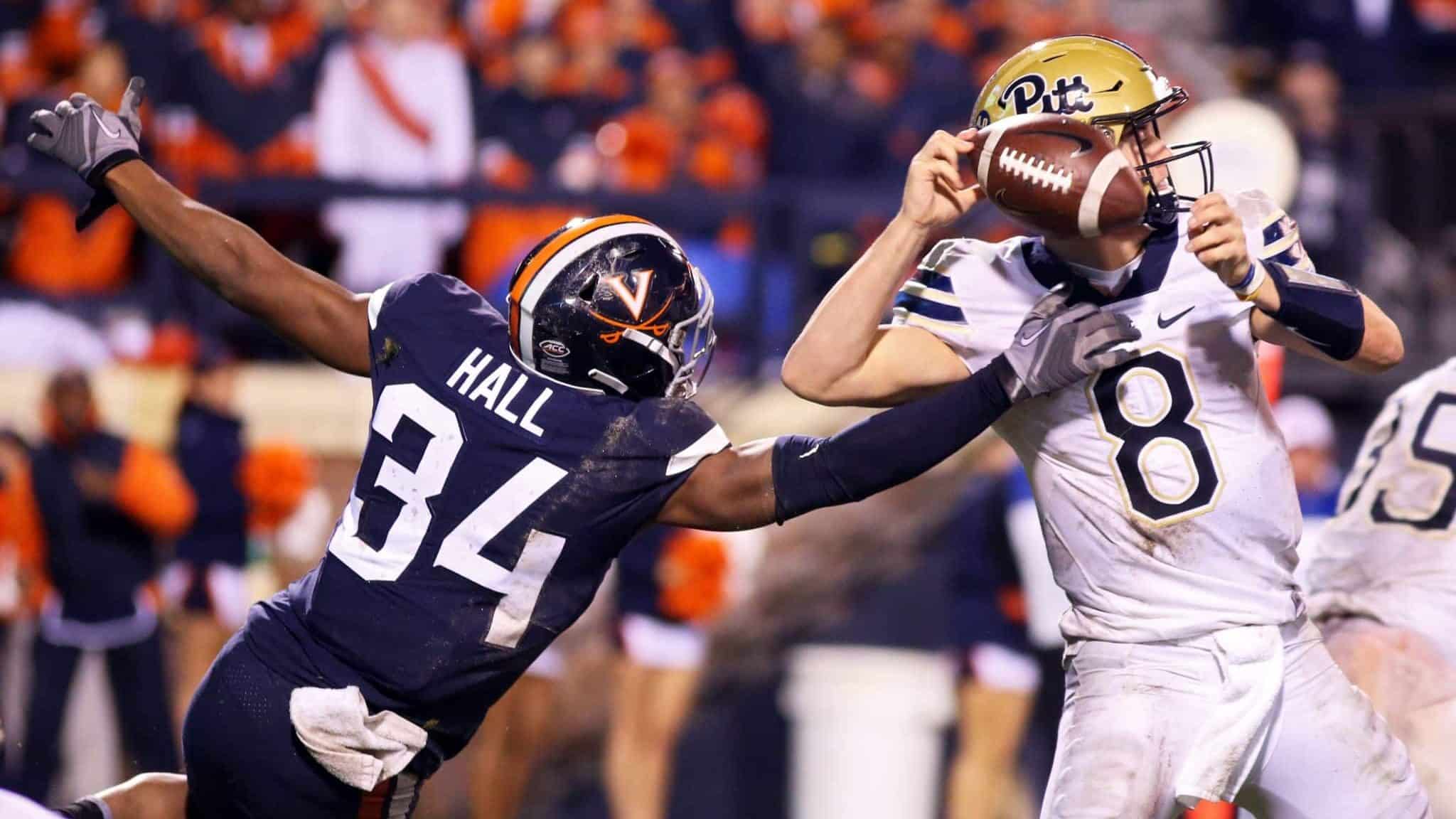 CHARLOTTESVILLE, VA - NOVEMBER 02: Bryce Hall #34 of the Virginia Cavaliers disrupts a pass by Kenny Pickett #8 of the Pittsburgh Panthers in the second half during a game at Scott Stadium on November 2, 2018 in Charlottesville, Virginia.