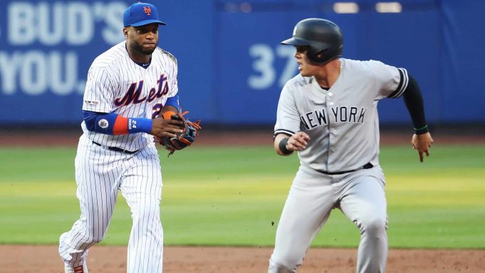 NEW YORK, NEW YORK - JULY 03: Robinson Cano #24 of the New York Mets runs down Gio Urshela #29 of the New York Yankees in the second inning to complete a double play during their game at Citi Field on July 03, 2019 in New York City. MLB