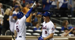 NEW YORK, NEW YORK - SEPTEMBER 14: Brandon Nimmo #9 of the New York Mets celebrates with teammate Jeff McNeil #6 after scoring a run in the eighth inning against the Los Angeles Dodgers at Citi Field on September 14, 2019 in New York City.