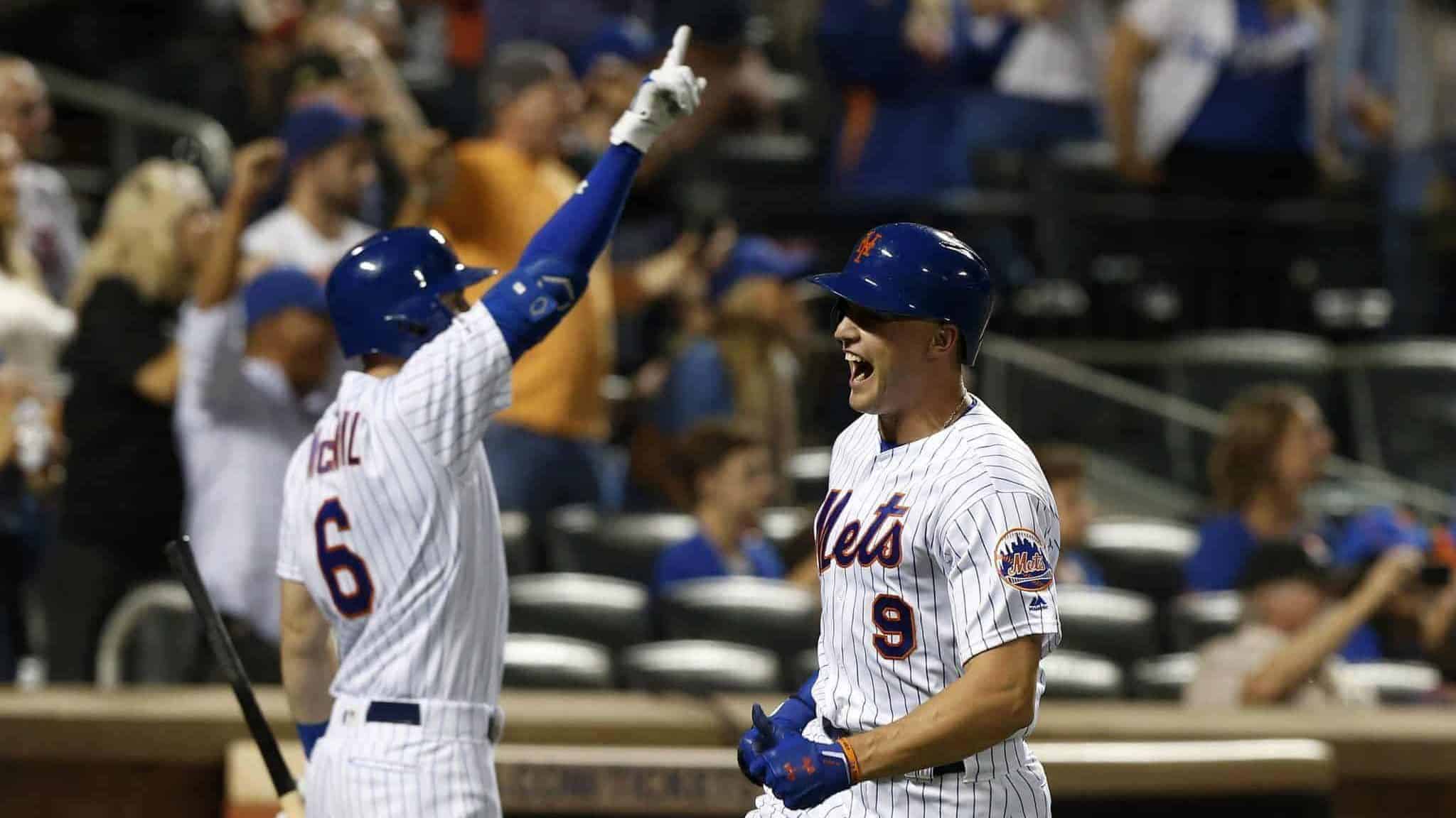 NEW YORK, NEW YORK - SEPTEMBER 14: Brandon Nimmo #9 of the New York Mets celebrates with teammate Jeff McNeil #6 after scoring a run in the eighth inning against the Los Angeles Dodgers at Citi Field on September 14, 2019 in New York City.