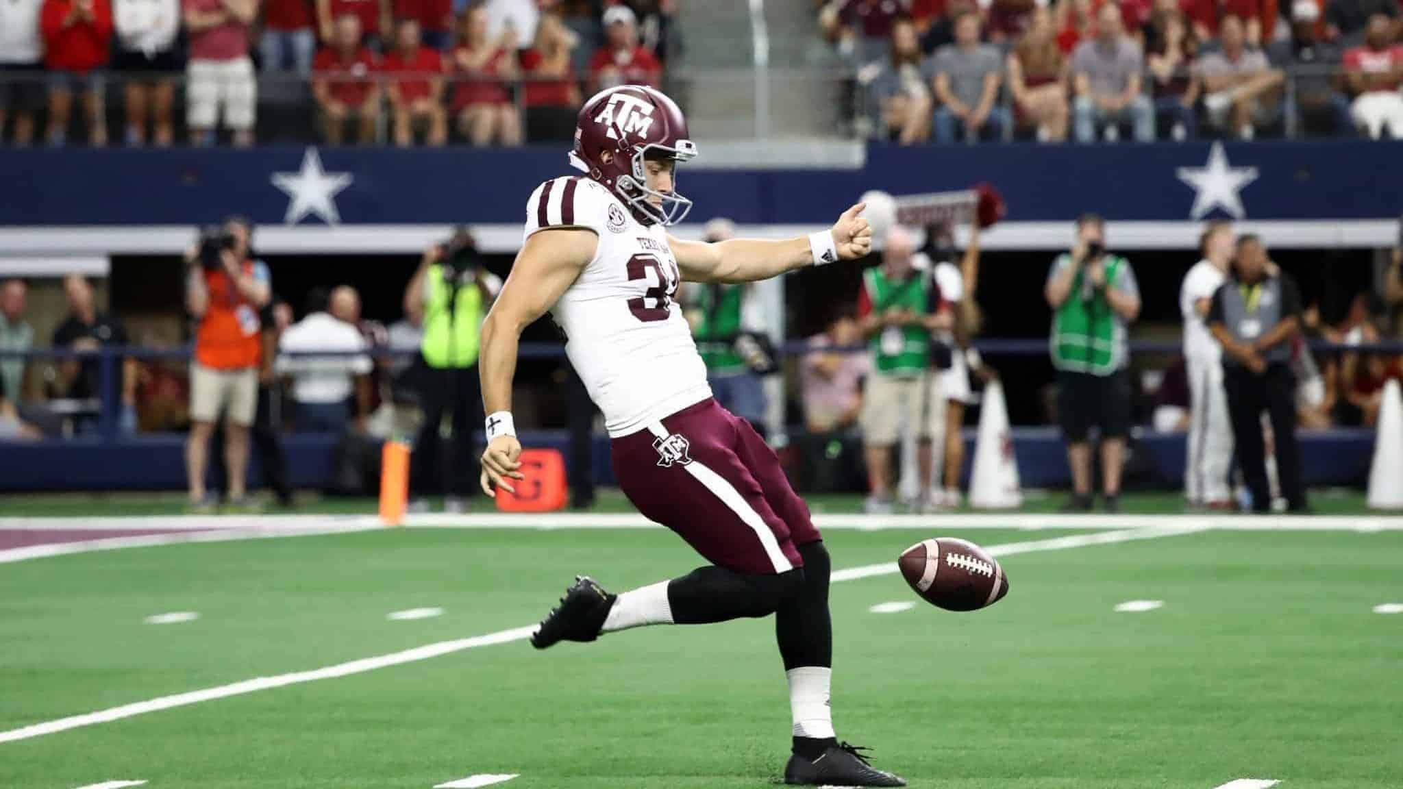 ARLINGTON, TEXAS - SEPTEMBER 28: Braden Mann #34 of the Texas A&M Aggies punts to the Arkansas Razorbacks in the second quarter during the Southwest Classic at AT&T Stadium on September 28, 2019 in Arlington, Texas. New York Jets