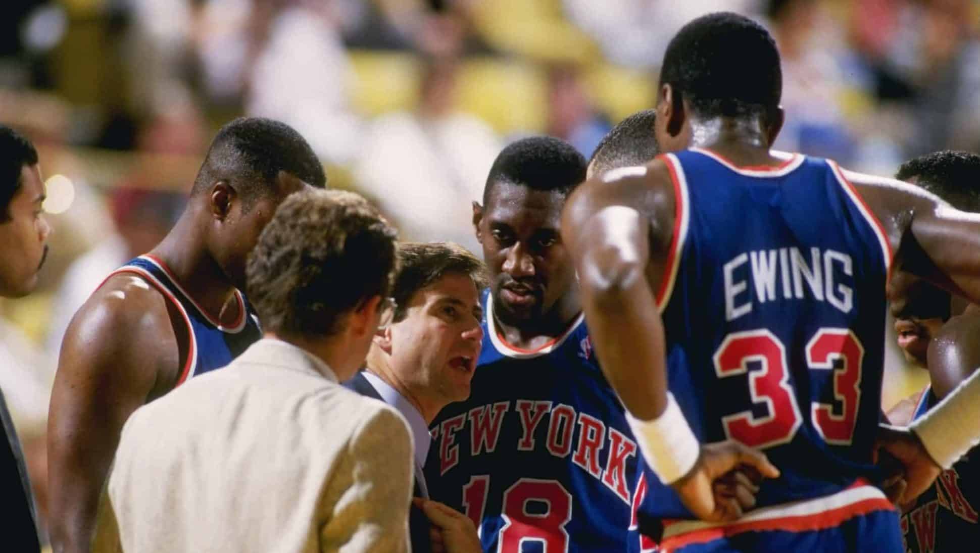 Oct 1987: Head coach Rick Pitino of the New York Knicks talks to Patrick Ewing #33 and other teammates during a Knicks versus Los Angeles Lakers game at the Great Western Forum in Inglewood, California.
