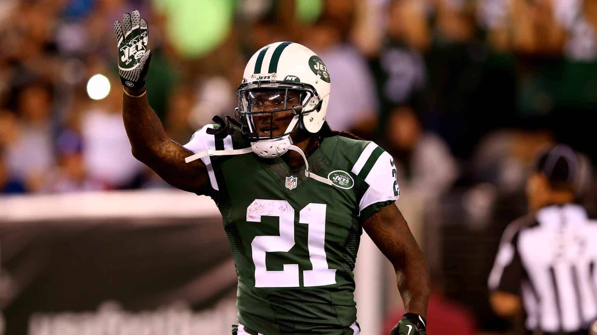 EAST RUTHERFORD, NJ - AUGUST 07: Running back Chris Johnson #21 of the New York Jets celebrates a touchdown against the Indianapolis Colts in the second quarter during a preseason game at MetLife Stadium on August 7, 2014 in East Rutherford, New Jersey.