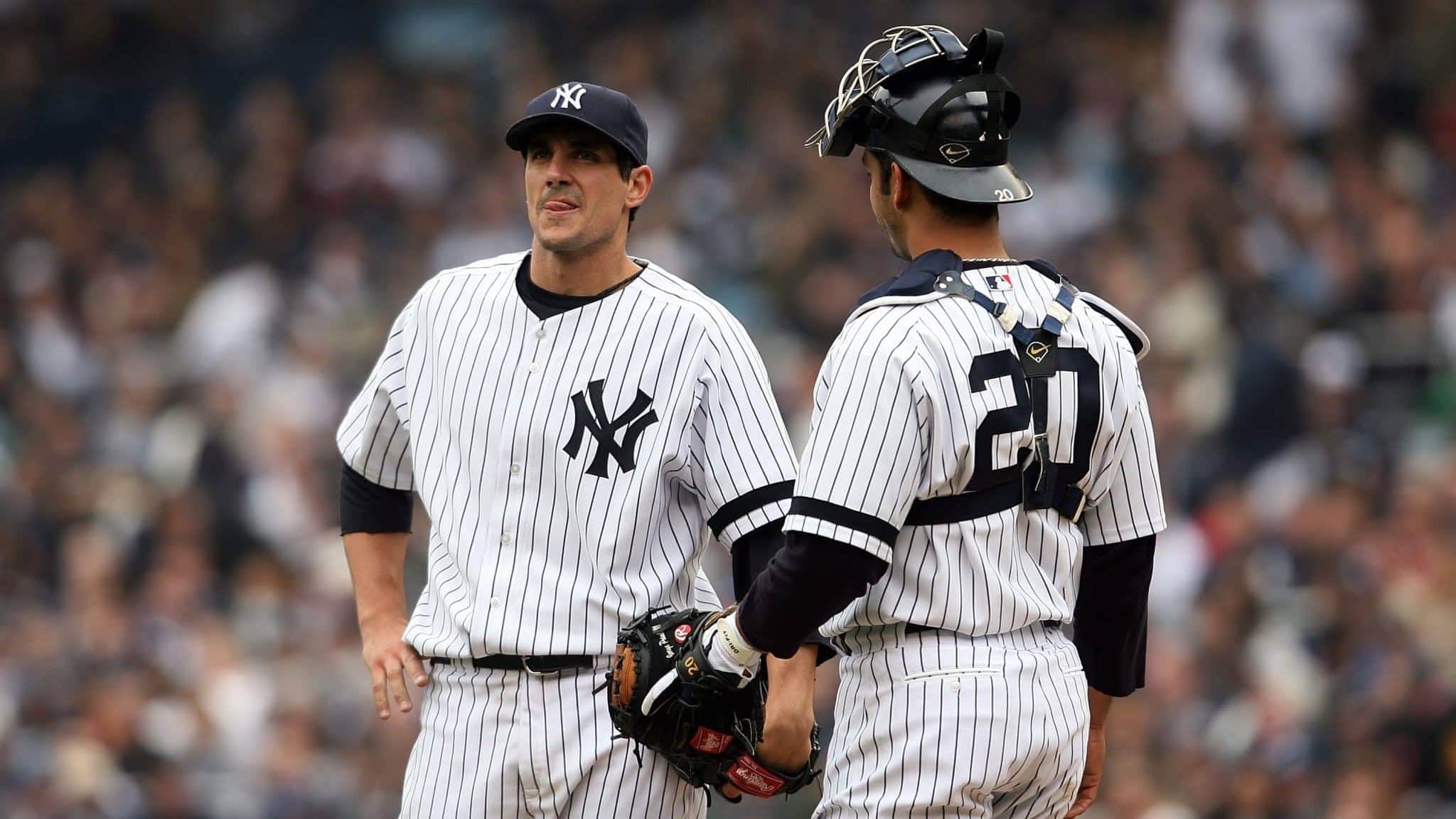 NEW YORK - APRIL 02: Starting pitcher Carl Pavano #45 of the New York Yankees talks with catcher Jorge Posada #20 on the mound after pitching against the Tampa Bay Devil Rays during their Opening Day game at Yankee Stadium April 2, 2007 in the Bronx borough of New York City. The Yankees defeated the Devil Rays, 9-5.