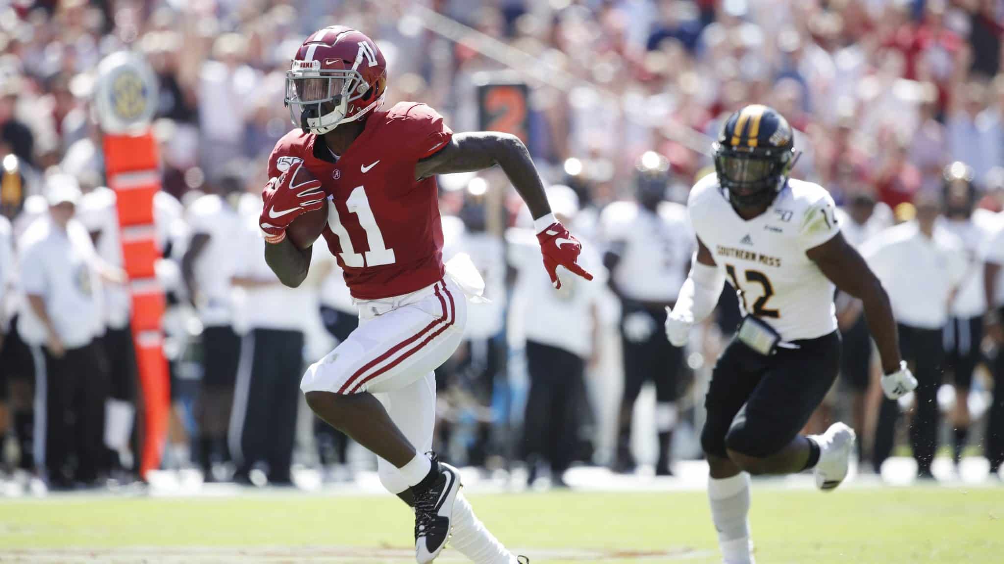 TUSCALOOSA, AL - SEPTEMBER 21: Henry Ruggs III #11 of the Alabama Crimson Tide runs for a 45-yard touchdown in the first quarter after catching a pass behind D.Q. Thomas #12 of the Southern Mississippi Golden Eagles at Bryant-Denny Stadium on September 21, 2019 in Tuscaloosa, Alabama. (
