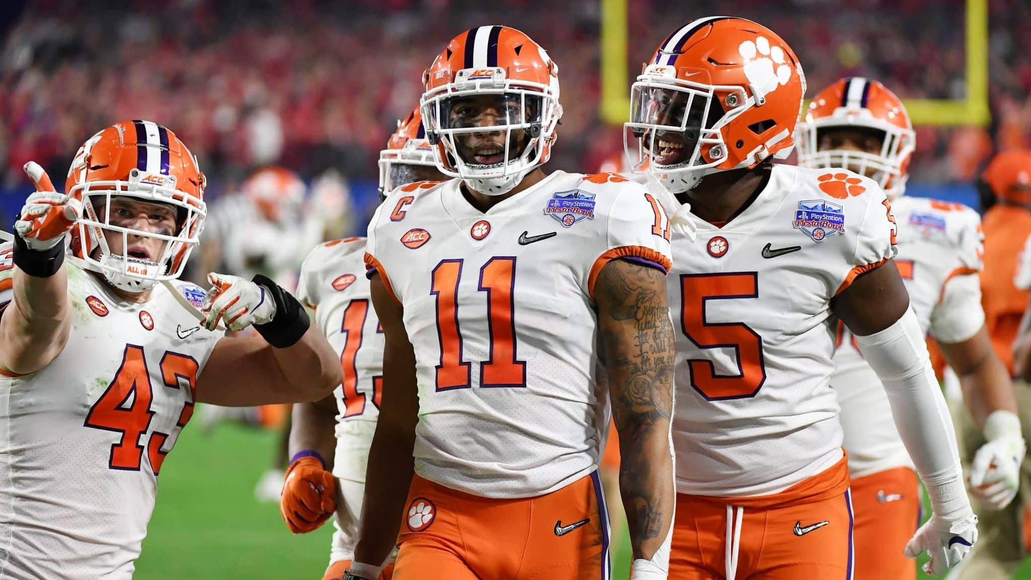 GLENDALE, ARIZONA - DECEMBER 28: Isaiah Simmons #11 of the Clemson Tigers is congratulated by his teammates after an interception against the Ohio State Buckeyes in the second half during the College Football Playoff Semifinal at the PlayStation Fiesta Bowl at State Farm Stadium on December 28, 2019 in Glendale, Arizona.