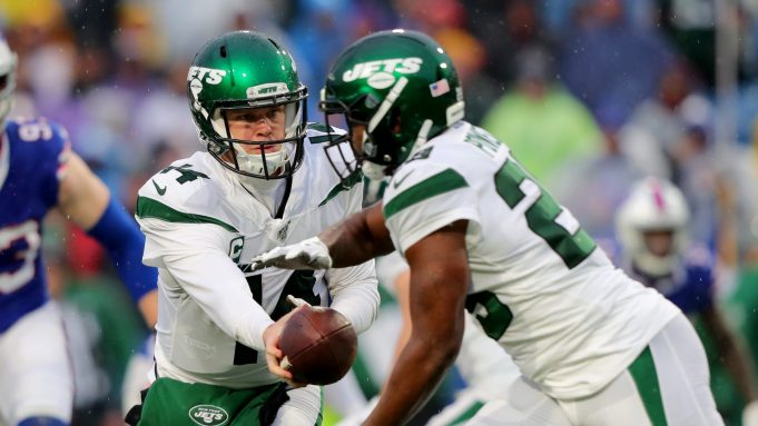 ORCHARD PARK, NY - DECEMBER 29: Sam Darnold #14 of the New York Jets hands the ball off to Bilal Powell #29 of the New York Jets during the second half against the Buffalo Bills at New Era Field on December 29, 2019 in Orchard Park, New York. Jets beat the Bills 13 to 6.
