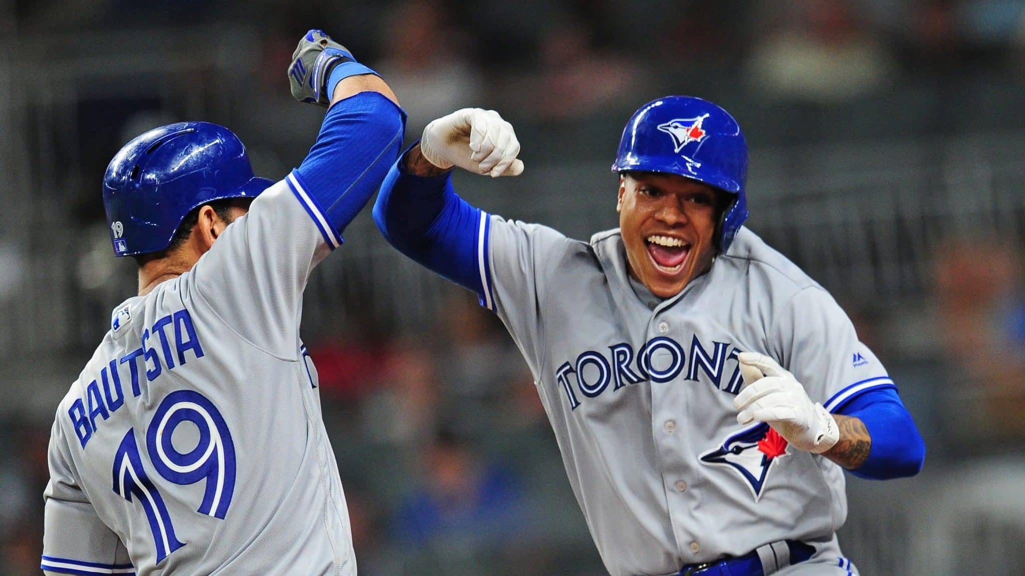 ATLANTA, GA - MAY 18: Marcus Stroman #6 of the Toronto Blue Jays is congratulated by Jose Bautista #19 after hitting a fourth inning solo home run against the Atlanta Braves at SunTrust Park on May 18, 2017 in Atlanta, Georgia.