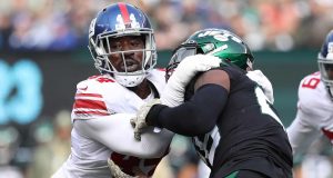 EAST RUTHERFORD, NEW JERSEY - NOVEMBER 10: Markus Golden #44 of the New York Giants pulls down Le'Veon Bell #26 of the New York Jets in the first quarter at MetLife Stadium on November 10, 2019 in East Rutherford, New Jersey.