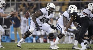 Connecticut offensive lineman Matt Peart (65) sets up to block during the second half of an NCAA college football game against Central Florida Saturday, Sept. 28, 2019, in Orlando, Fla.