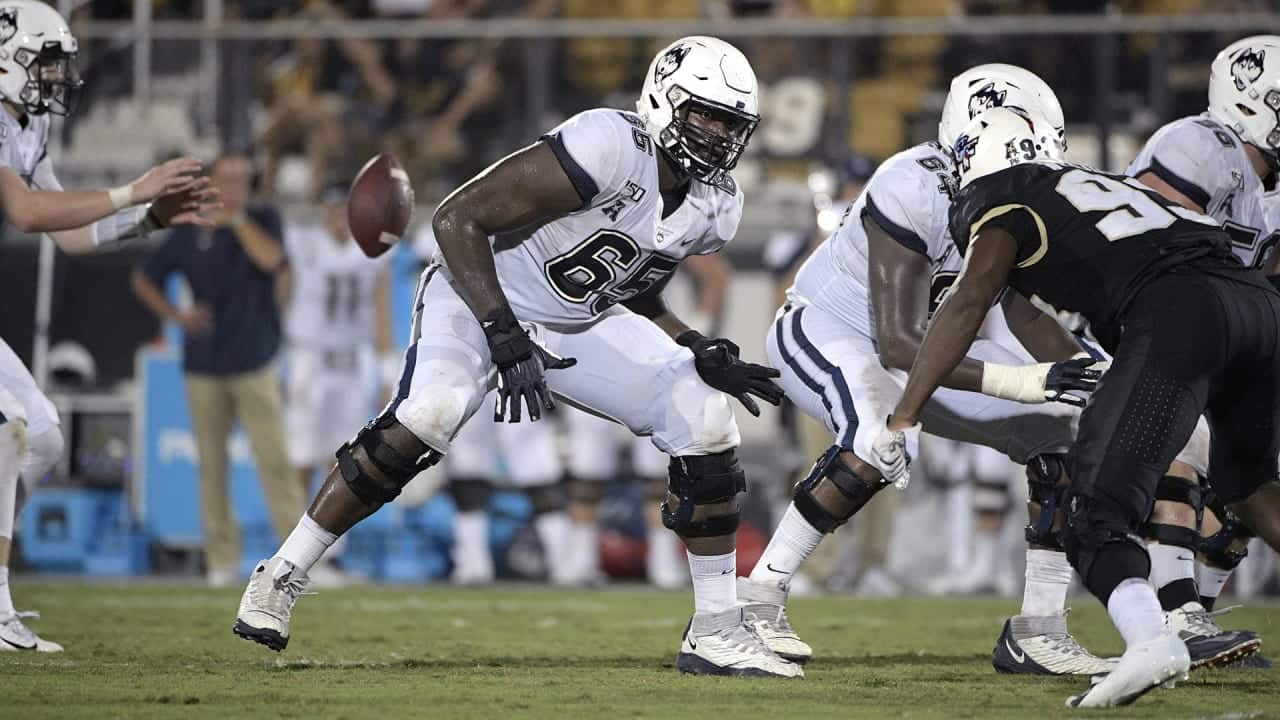 Connecticut offensive lineman Matt Peart (65) sets up to block during the second half of an NCAA college football game against Central Florida Saturday, Sept. 28, 2019, in Orlando, Fla.