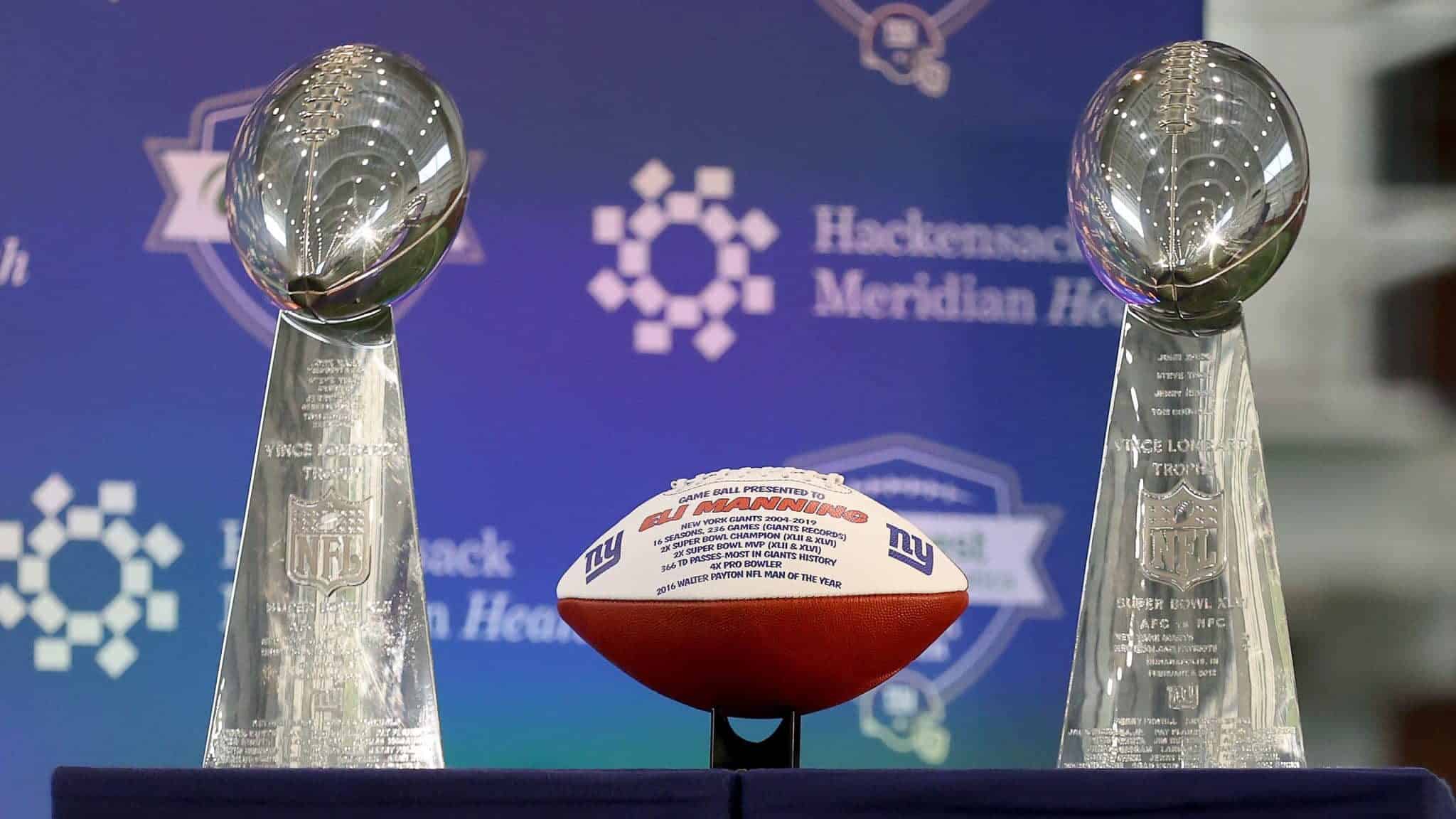 EAST RUTHERFORD, NEW JERSEY - JANUARY 24: A football listing all the accomplishments of Eli Manning of the New York Giants is on display with the Vince Lombardi trophies before Eli Manning announced his retirement during a press conference on January 24, 2020 at Quest Diagnostic Training Center in East Rutherford, New Jersey.The two time Super Bowl MVP is retiring after 16 seasons with the team.