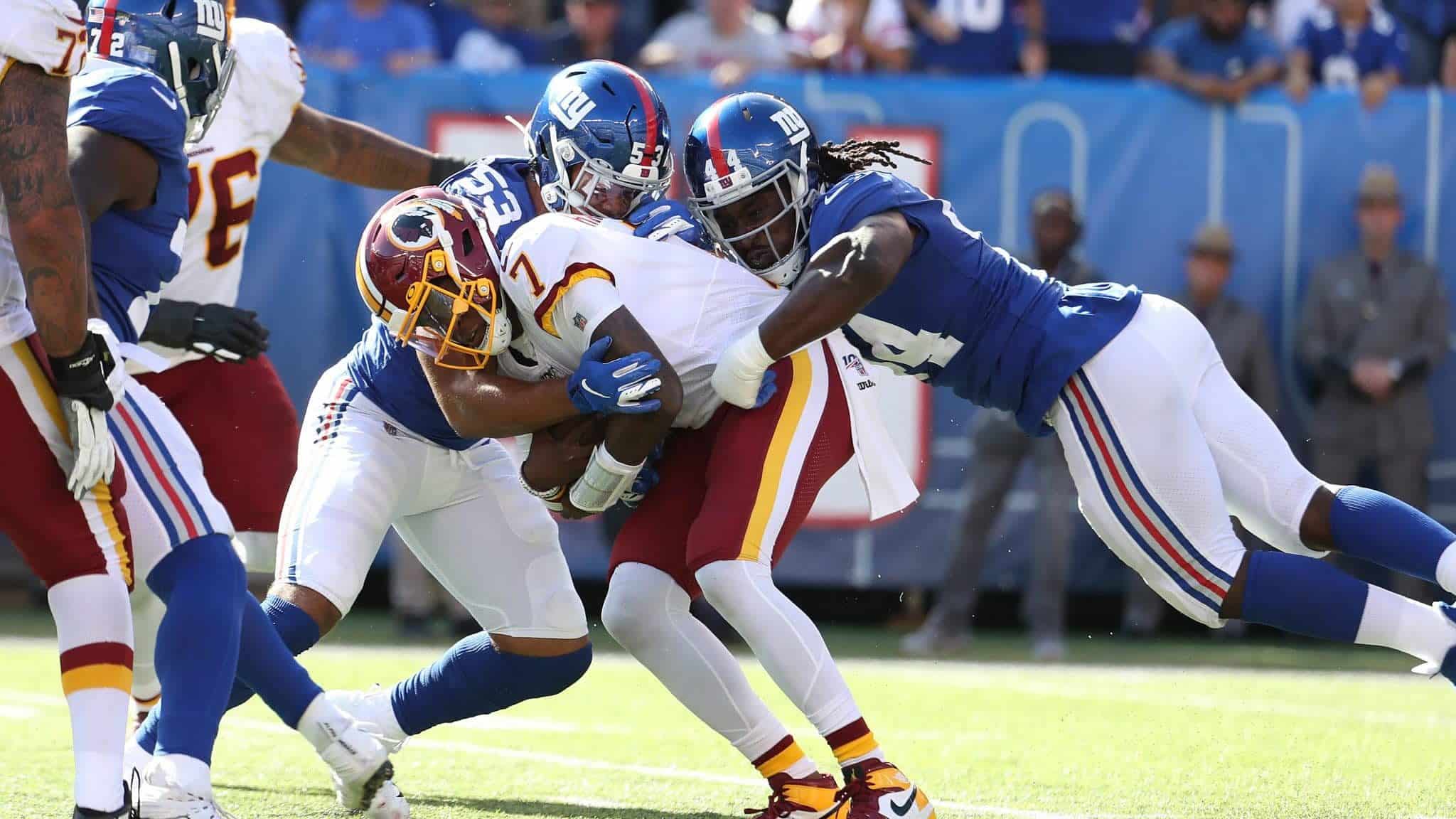 EAST RUTHERFORD, NEW JERSEY - SEPTEMBER 29: Oshane Ximines #53 and Markus Golden #44 of the New York Giants sack Dwayne Haskins #7 of the Washington Redskins during their game at MetLife Stadium on September 29, 2019 in East Rutherford, New Jersey.