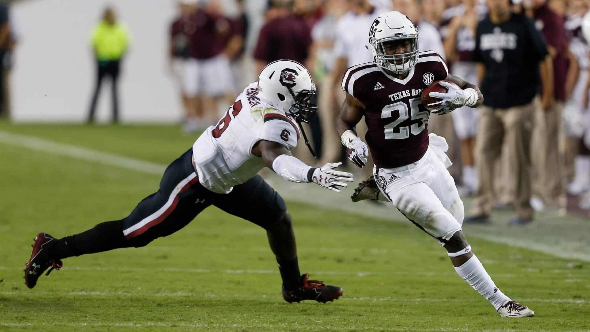COLLEGE STATION, TX - SEPTEMBER 30: Kendall Bussey #25 of the Texas A&M Aggies rushes past T.J. Brunson #6 of the South Carolina Gamecocks at Kyle Field on September 30, 2017 in College Station, Texas.