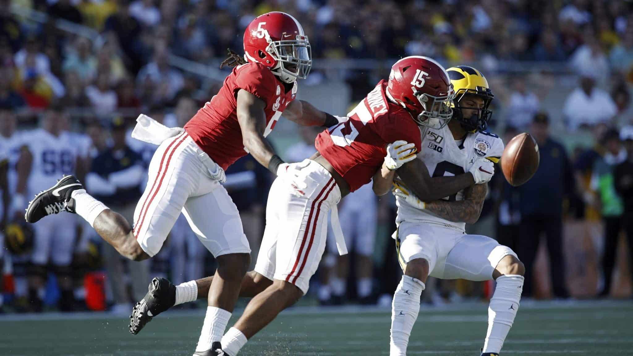 ORLANDO, FL - JANUARY 01: Xavier McKinney #15 and Shyheim Carter #5 of the Alabama Crimson Tide defend a pass against Ronnie Bell #8 of the Michigan Wolverines in the third quarter of the Vrbo Citrus Bowl at Camping World Stadium on January 1, 2020 in Orlando, Florida. Alabama defeated Michigan 35-16.
