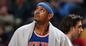 DENVER, CO - MARCH 08: Carmelo Anthony #7 of the New York Knicks looks on as he sits on the bench late in the game against the Denver Nuggets at Pepsi Center on March 8, 2016 in Denver, Colorado. The Nuggets defeated the Knicks 110-94. NOTE TO USER: User expressly acknowledges and agrees that, by downloading and or using this photograph, User is consenting to the terms and conditions of the Getty Images License Agreement.