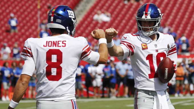 TAMPA, FLORIDA - SEPTEMBER 22: Quarterbacks Daniel Jones #8 and Eli Manning #10 of the New York Giants fist bump during warmups before the game against the Tampa Bay Buccaneers at Raymond James Stadium on September 22, 2019 in Tampa, Florida.