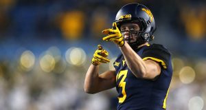 MORGANTOWN, WV - OCTOBER 25: David Sills V #13 of the West Virginia Mountaineers reacts after a first down in the first half against the Baylor Bears at Mountaineer Field on October 25, 2018 in Morgantown, West Virginia.