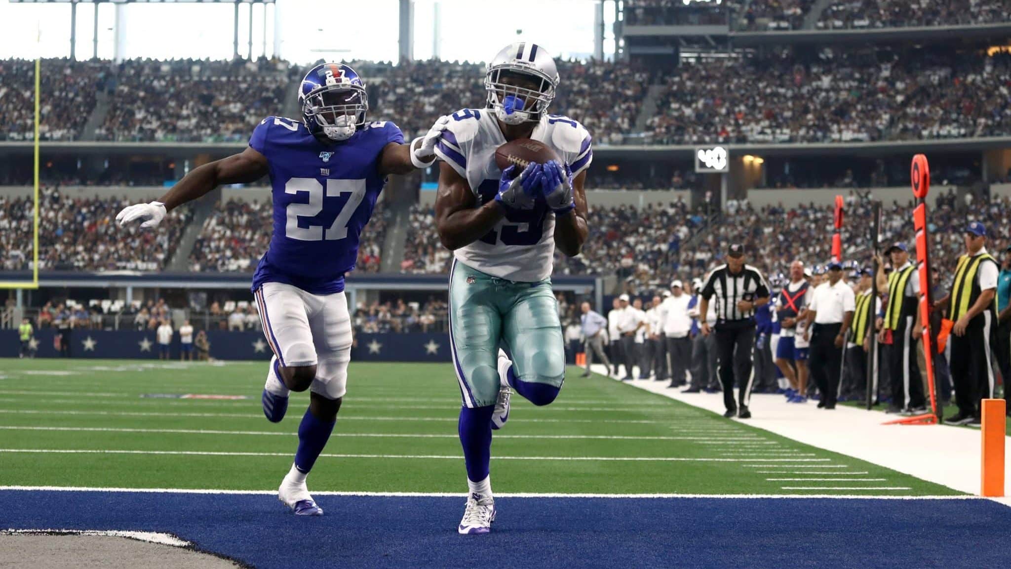 ARLINGTON, TEXAS - SEPTEMBER 08: Wide receiver Amari Cooper #19 of the Dallas Cowboys makes the recption for a touchdown in front of cornerback Deandre Baker #27 of the New York Giants during the second quarter of the game at AT&T Stadium on September 08, 2019 in Arlington, Texas.